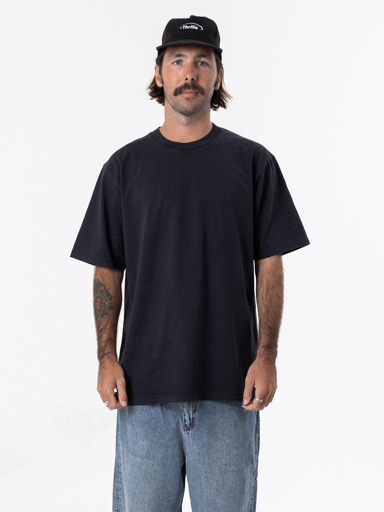 Male model wearing our Thrills Thrills Military Oversize Fit Tee in Blue standing against a plain studio background.