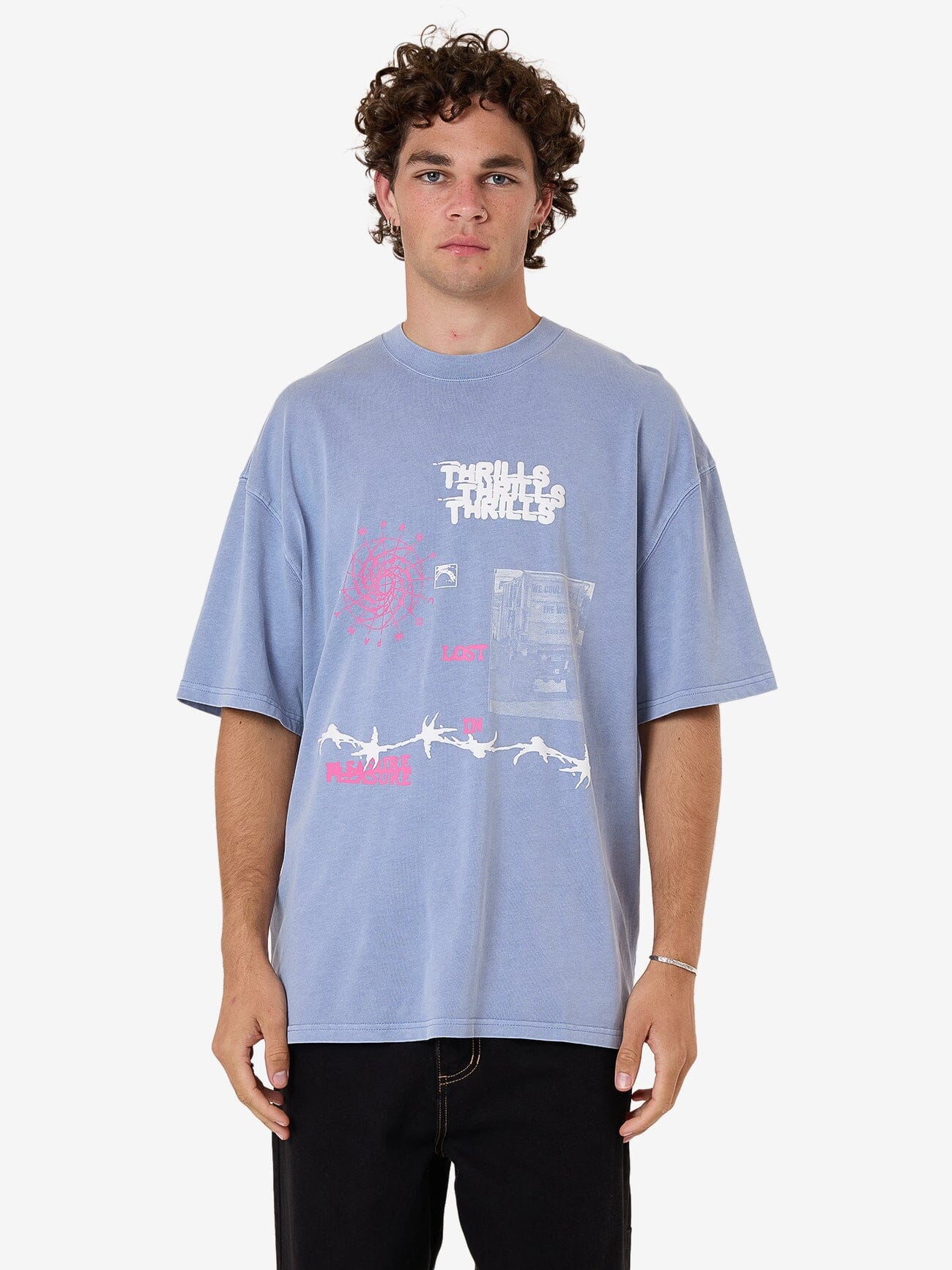 Male model wearing our Thrills Connections Box Fit Oversize Tee in Blue standing against a plain studio background.