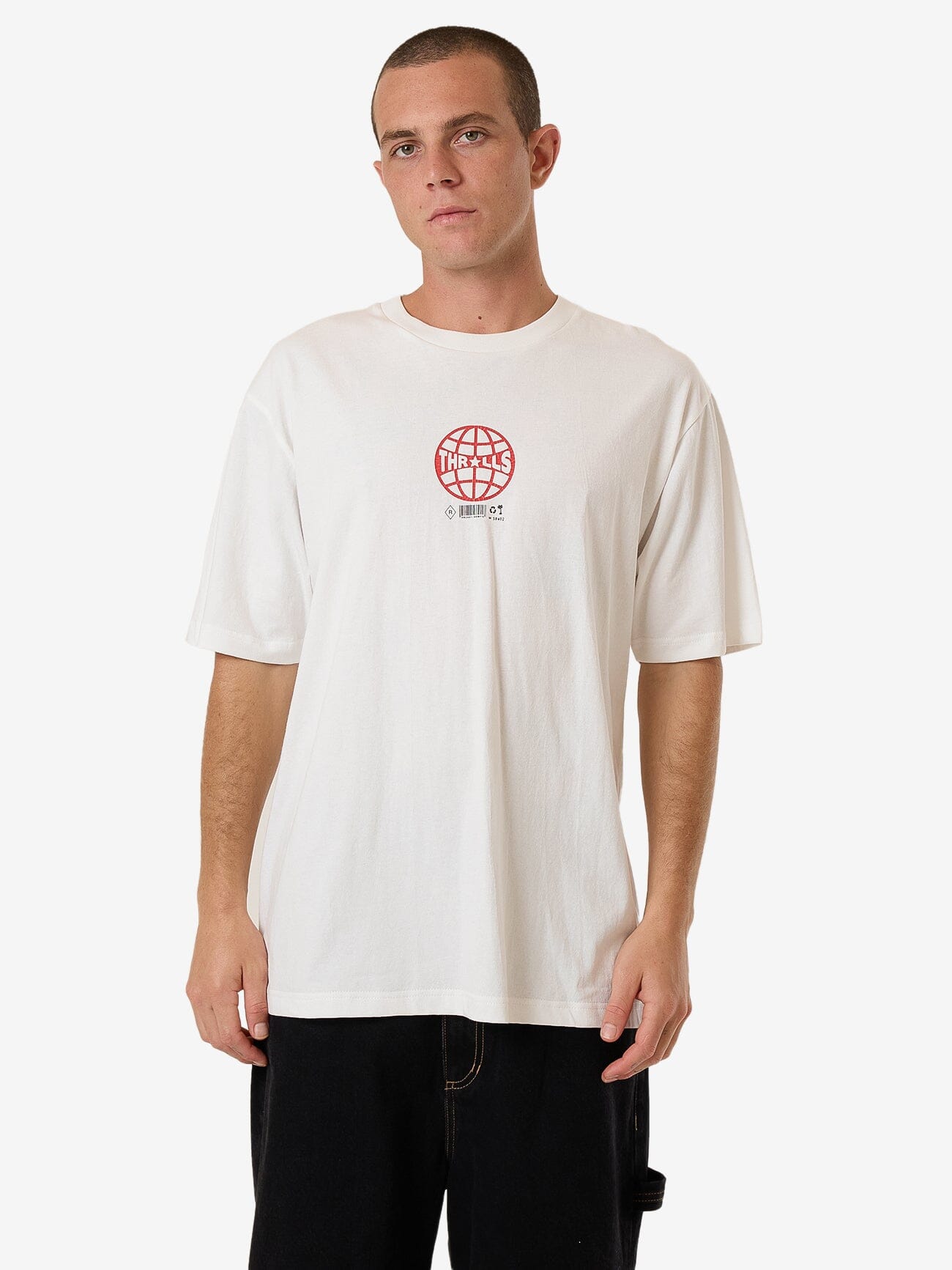 Male model wearing our Thrills Hidden Agenda Oversize Fit Tee in White standing against a plain studio background.