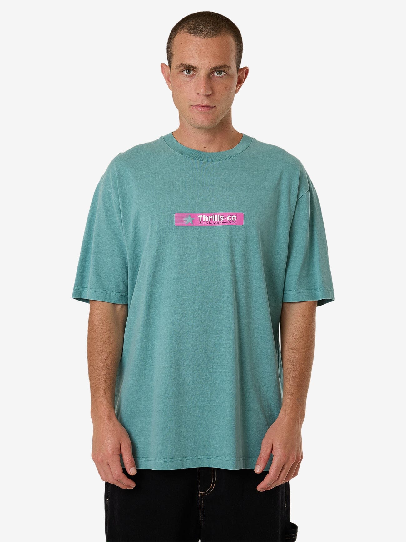 Male model wearing our Thrills Games Of 84' Oversize Fit Tee in Green standing against a plain studio background.
