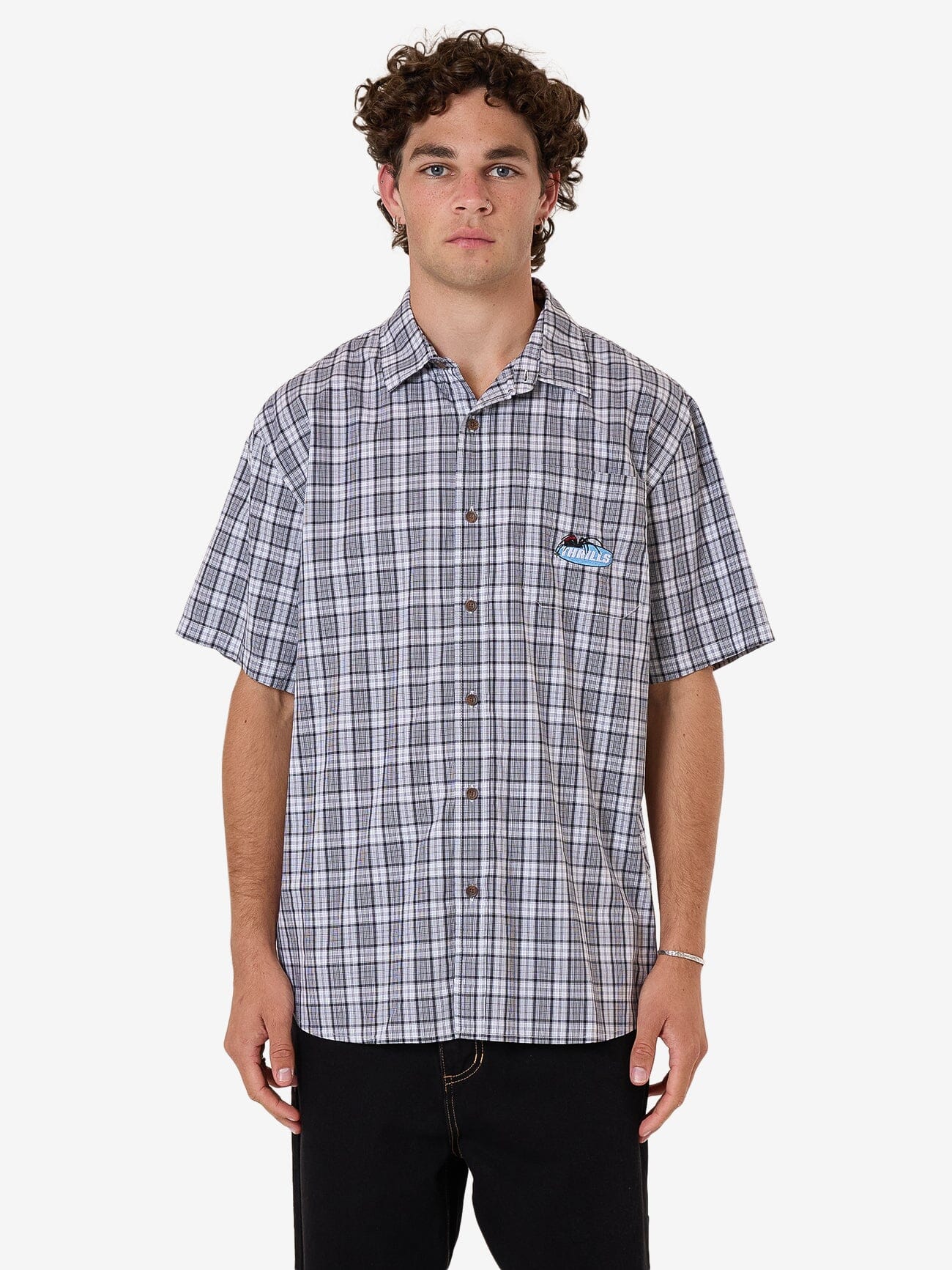 Male model wearing our Thrills Trust In Us Short Sleeve Shirt in White standing against a plain studio background.