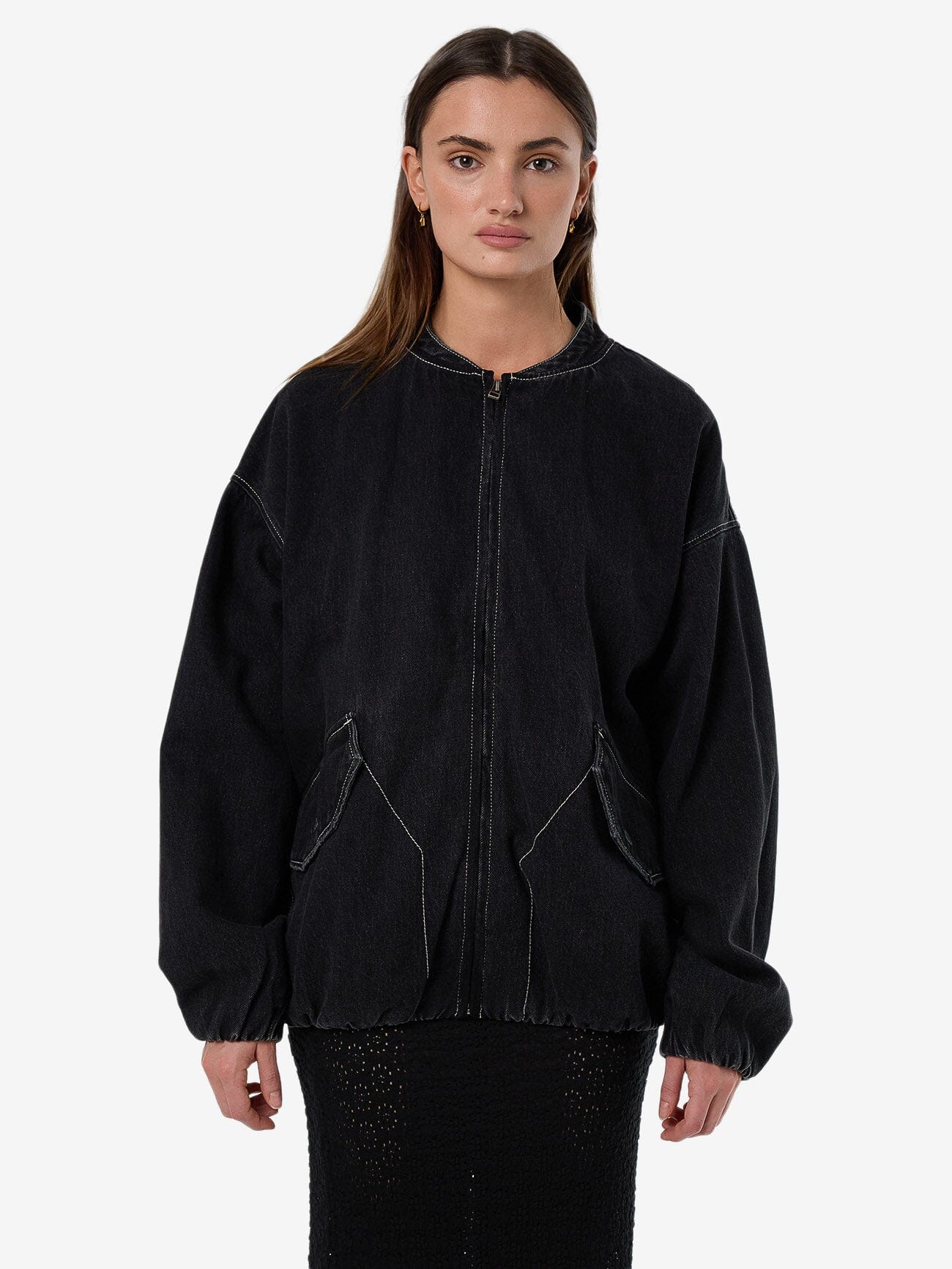Female model wearing our Thrills Rayne Oversized Bomber in Black standing against a plain studio background.
