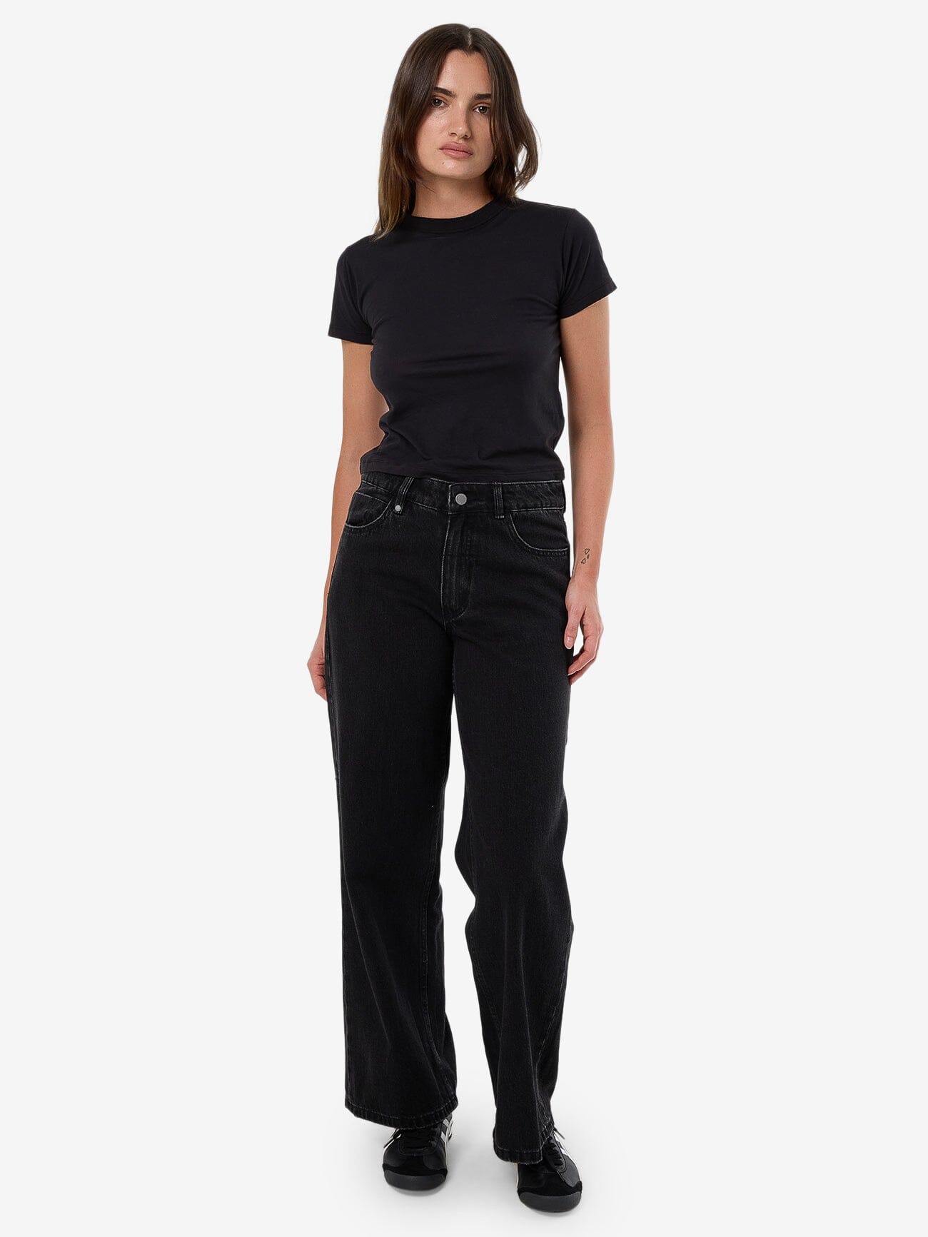 Female model wearing our Thrills Billie Low Jean in Black standing against a plain studio background.