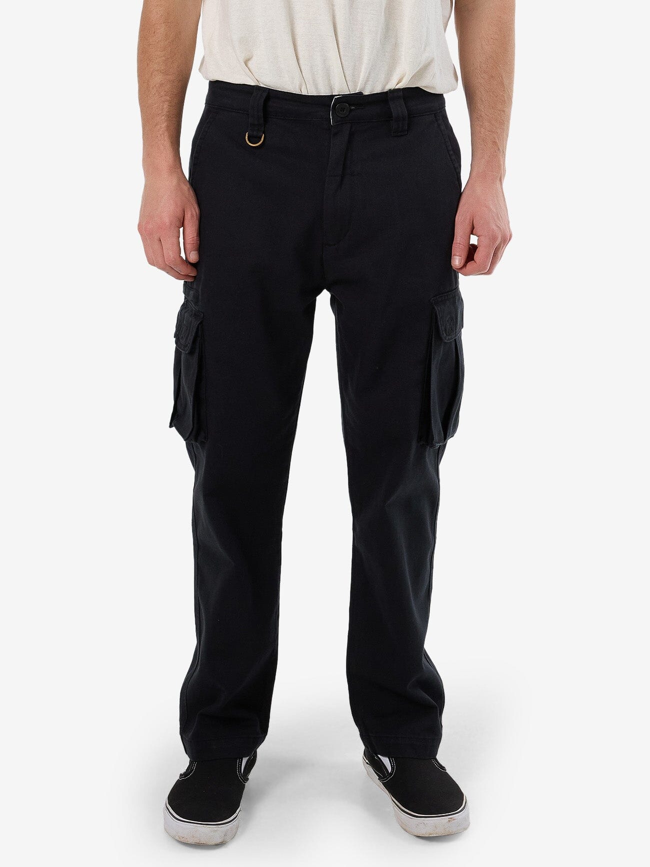 Male model wearing our Thrills Slacker Union Cargo Pant in Black standing against a plain studio background.